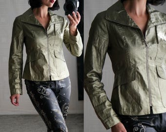 May include: A green satin jacket with a zipper closure and a collar. The jacket has a fitted silhouette and is worn with black pants.