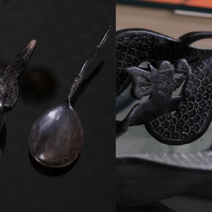 May include: A dark, polished horn spoon featuring an elongated handle with intricate, etched scale patterns. The bowl of the spoon is smooth and translucent with natural marbling. A second view shows a close-up of the carved dragon-like motif.