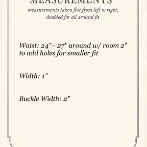 May include: Cream-coloured card with black text detailing measurements. The text reads: "MEASUREMENTS" followed by waist measurements of 61-69 cm, width of 2.5 cm, and buckle width of 5 cm. The card has a decorative border.