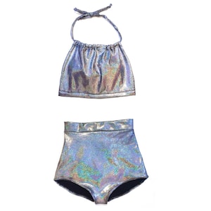 May include: A silver iridescent halter top and high-waisted bikini bottoms. The fabric has a shimmery, holographic finish.