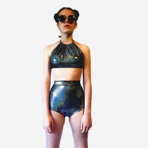 May include: A black and blue iridescent halter top and high-waisted shorts set. The fabric has a sparkly, glittery texture.