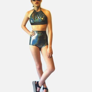 May include: A black and iridescent halter top and high-waisted shorts set. The top has a gathered neckline and the shorts have a high-cut leg.