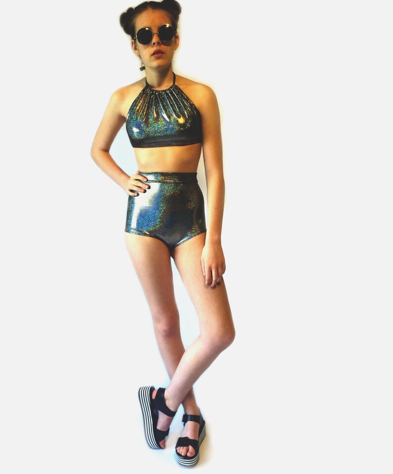 May include: A black and iridescent halter top and high-waisted shorts set. The top has a gathered neckline and the shorts have a high-cut leg.
