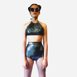 May include: A black and iridescent halter top and high-waisted shorts set with a sparkly finish.