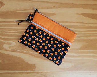 Extra small notion pouch with two zipper pockets featuring candy corn fabric