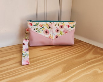 Small clutch with florals and pink panels; detachable wrist strap to make wristlet