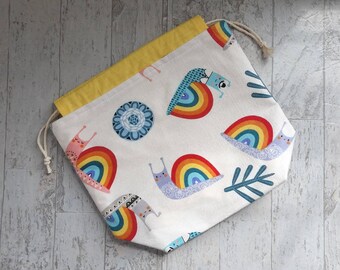 Medium rainbow snails project bag for knitting, crochet, needlework; soft snail print drawstring pouch with pockets