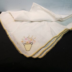Linen small table cloth, thristles decorated embroidered with a still life basket on each corner. Artisan hand made embroidery.