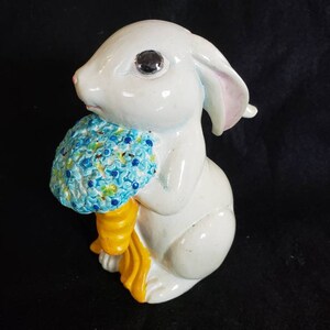 Easter bunny Rabbit with a floral  blue egg.