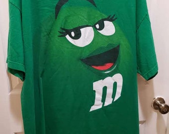 Rare find green t shirt with an m m smile, size two X Large, M M production,