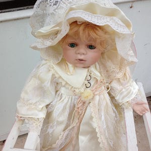 Doll, Porcelain doll by Duck House Heirloom Doll with blue eyes and open mouth.