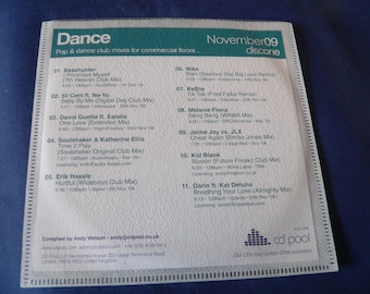 May include: A white CD cover with a green and black title "Dance" and a list of songs with artists and release dates. The CD is part of a compilation series called "November 09 discone".