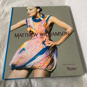 May include: A book cover featuring a model wearing a colorful, patterned dress. The book title is "Matthew Williamson" and the publisher is "Rizzoli New York".