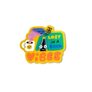 May include: Yellow sticker with a cartoon illustration of a book, a coffee mug, and a cloud. The text on the sticker reads "Lost in a book vibes".