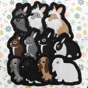 May include: A set of 10 embroidered iron-on patches featuring different breeds of rabbits in various colors. The patches are perfect for adding a touch of whimsy to clothing, bags, or other fabric items.