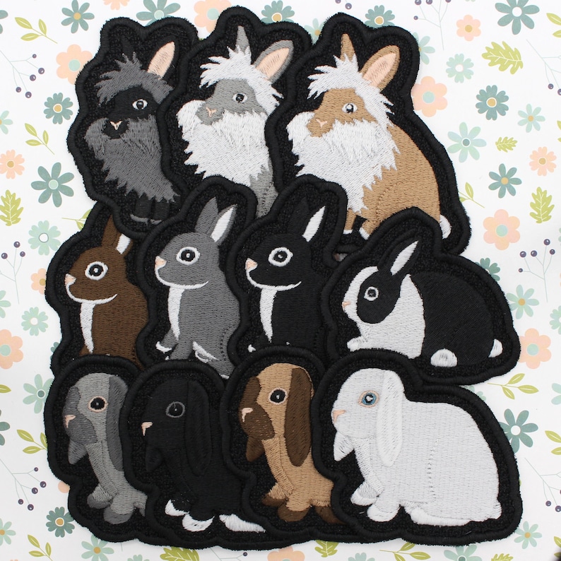 May include: A set of 10 embroidered iron-on patches featuring different breeds of rabbits in various colors. The patches are perfect for adding a touch of whimsy to clothing, bags, or other fabric items.