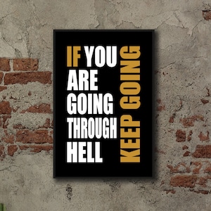 May include: A framed print with the motivational quote "IF YOU ARE GOING THROUGH HELL KEEP GOING". The text is in white and gold against a black background. The print hangs on a textured wall.