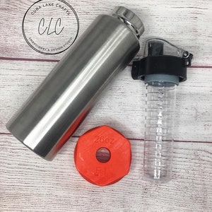 May include: A stainless steel water bottle with a black lid and a red 26oz lid. The bottle is next to a clear plastic water bottle with a black lid.