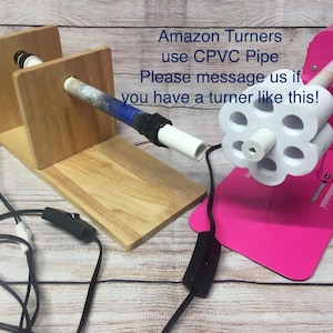 May include: Two wood and pink electric pottery turning wheels with a white plastic pipe and a white plastic wheel with holes. The text on the image reads "Amazon Turners use CPVC Pipe Please message us if you have a turner like this!"