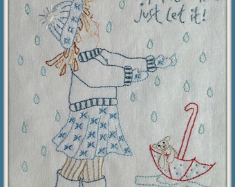 May include: Embroidered design of a girl in a blue and white dress and a red hat standing in a puddle with a red umbrella with a teddy bear inside. The text "When it rains just let it!" is embroidered above the girl.