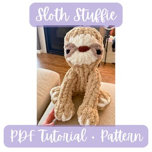 May include: A crocheted sloth toy in beige, cream, and brown. The sloth has a textured, fluffy body, with a cream-colored face and paws. The text "Sloth Stuffie" and "PDF Tutorial + Pattern" are displayed in a purple banner.