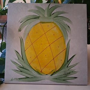 May include: A handmade wooden sign displaying the word "Welcome" in a whimsical font. It has a distressed white background and a dark brown frame, suitable for a front door or hallway.