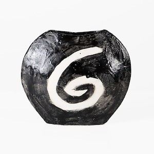 May include: Black ceramic vase with a white spiral design. The vase has a rounded shape and a glossy finish.