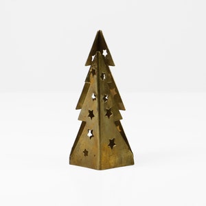 May include: A gold metal Christmas tree ornament with a cut-out star design.