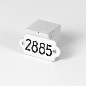 May include: White ceramic number tag with the number 2885 printed in black.
