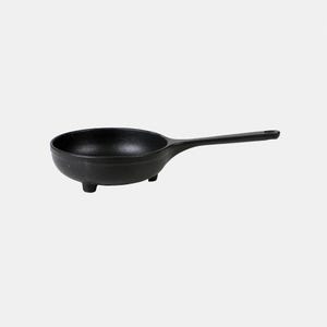 May include: A black cast iron frying pan with a long handle and three small feet. The pan is round with a deep bowl shape. The handle has a hole for hanging. This cookware is ideal for cooking.