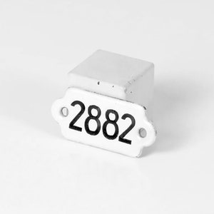 May include: White ceramic number plaque with the number 2882 printed in black.