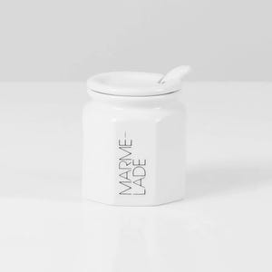 May include: White ceramic jar with a lid and a small spoon. The jar has the text "MARME-LADE" printed on the side.