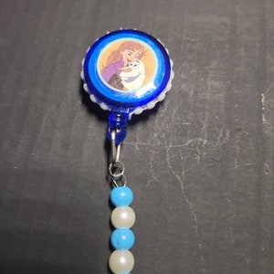 Blue badge clip with sticker lined with pearls