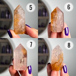 May include: Four clear quartz crystal points with inclusions of orange and brown. The crystals are arranged in a grid pattern with numbers 5, 6, 7, and 8 in the corners.