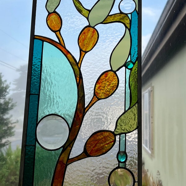 Stained glass kelp window with round bevels.