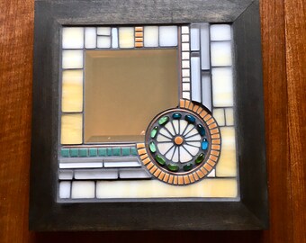 Stained glass and tile mosaic with beveled mirror, copper wire in a wood frame.