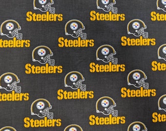 May include: A black fabric with a repeating pattern of yellow "Steelers" text and a black and white football helmet graphic.