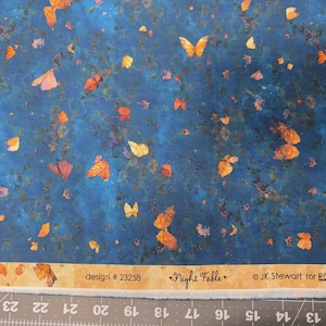 May include: Fabric with a dark blue background and scattered orange and yellow butterflies. The fabric has a textured appearance with the words "Night Fable" and "design # 23258" printed on it.