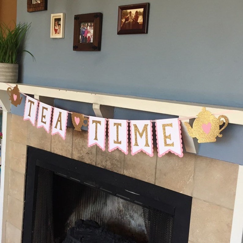 May include: A pink and gold tea party banner with the words "TEA TIME" and a teapot and teacup design.