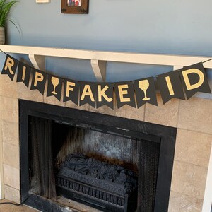 May include: Black and gold banner with the text "RIP FAKE ID" and a wine glass icon between the words "RIP" and "FAKE".