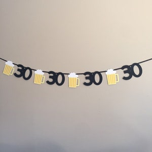 May include: Black and yellow paper banner with the number 30 repeated and beer mug cutouts.