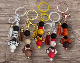 Show off your love for the game with these adorable handmade sports-themed beaded keychains! Customized team colors available upon request.