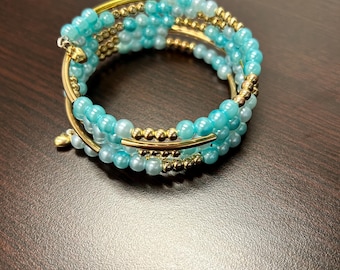 Light blue and gold memory wire wrap bracelet with heart charm details