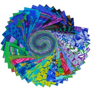 May include: A circular arrangement of fabric strips featuring a variety of patterns and colours including blue, green, purple, yellow, and pink. The strips are arranged in a spiral, showcasing floral, geometric, and polka dot designs with pinked edges.