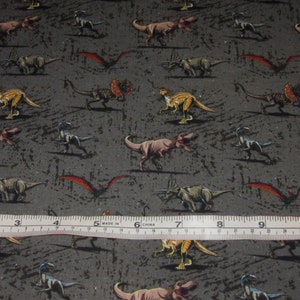 dinosaur print dinosaurs on a dark grey background cotton remnant UK seller