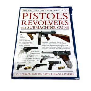 May include: A book titled "The Illustrated Encyclopedia of Pistols, Revolvers, and Submachine Guns." The cover features images of various firearms. The book includes a historical reference to over 500 military and antique firearms.