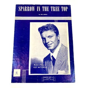 May include: Vintage sheet music titled "Sparrow in the Tree Top" by Bob Merrill, featuring Guy Mitchell. The cover is a deep blue with white text and a black and white photo of Mitchell. The price is 40 cents.