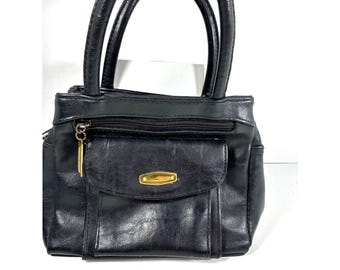 Bolso organizador vintage de cuero negro con 8 bolsillos y asa superior, estilo clásico de abuela.