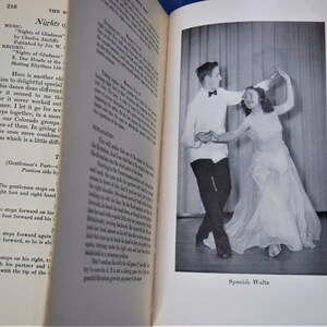 May include: A black and white photograph of a couple dancing the Spanish Waltz. The man is wearing a white shirt with a black bow tie and black pants. The woman is wearing a white dress. The caption below the photo reads "Spanish Waltz."