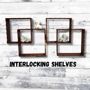 May include: Interlocking shelves with a rustic, brown finish. The shelves are square-shaped and feature small ceramic cat figurines. The text "INTERLOCKING SHELVES" is displayed in black letters.